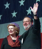 U.S. Senators Debbie Stabenow, left, and Gary Peters briefly stand together on stage after she introduces him after her speech and before his.