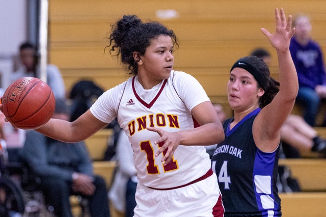 Tulare Union's Kiara Brown passes under pressure from Mission Oak's Kayleigh Lopes in a girls basketball game on Friday, February 1, 2019.