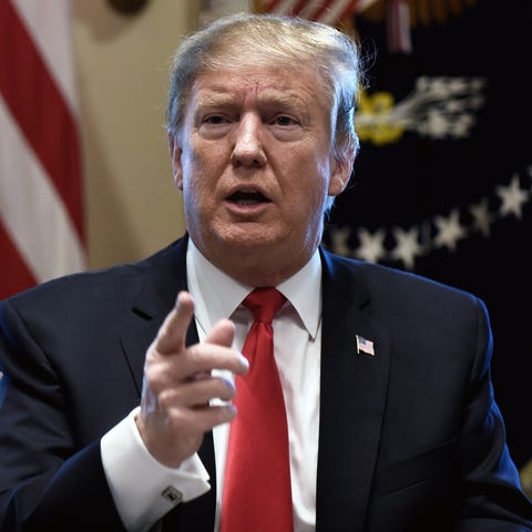 President Donald J. Trump answers questions from...