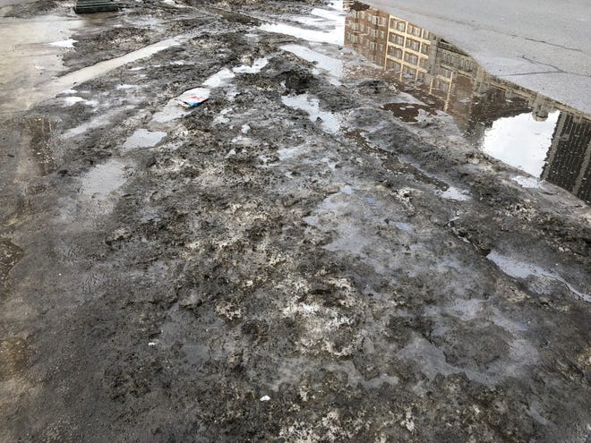 Dirt, water and slush pile up on Fort Street in Detroit on Feb. 4, 2019.