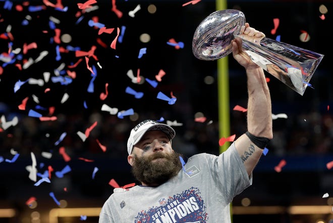 New England's Julian Edelman holds the Lombardi trophy after the game.