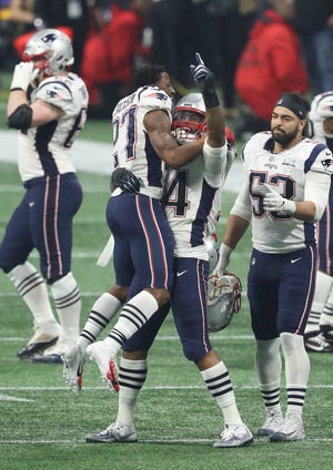 Patriots defensive back J.C. Jackson, outside linebacker Dont'a Hightower and middle linebacker Kyle Van Noy, right,  celebrate after defeating the Los Angeles Rams in Super Bowl LIII on Feb. 3, 2019, in Atlanta.