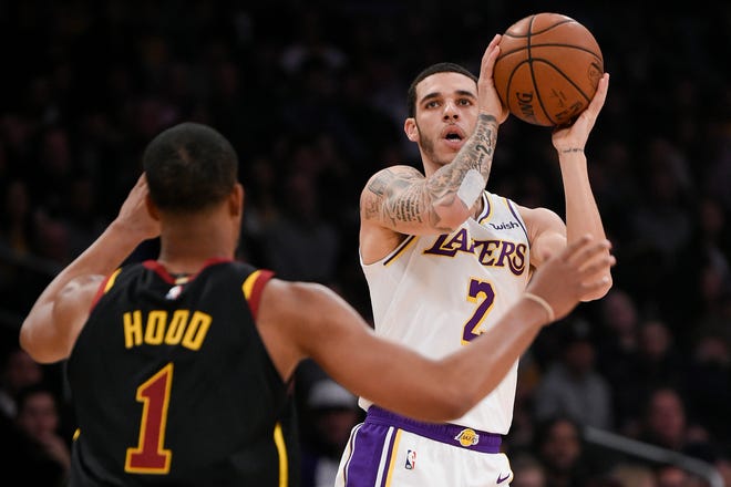 Lakers point guard Lonzo Ball looks to shoot over Cavaliers guard Rodney Hood during a game Jan. 13 at Staples Center.