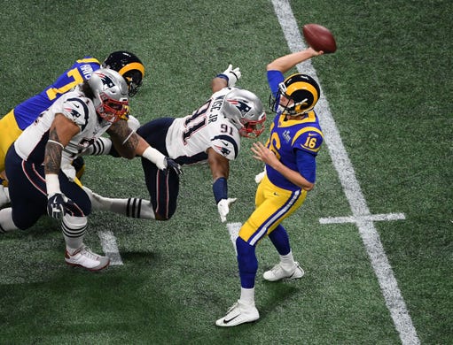 New England Patriots defensive end Deatrich Wise (91) bears down on Los Angeles Rams quarterback Jared Goff (16) during the first quarter of Super Bowl LIII.