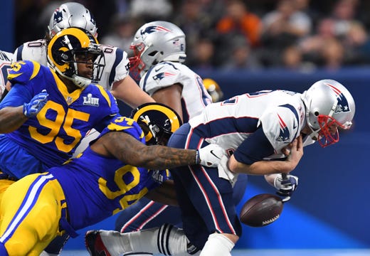 Los Angeles Rams defensive end John Franklin-Myers (94) sacks New England Patriots quarterback Tom Brady (12), who fumbles the ball, during the first quarter of Super Bowl LIII. The Patriots recovered the fumble.