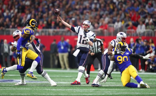 New England Patriots quarterback Tom Brady (12) throws a pass against the Los Angeles Rams in the first quarter in Super Bowl LIII.