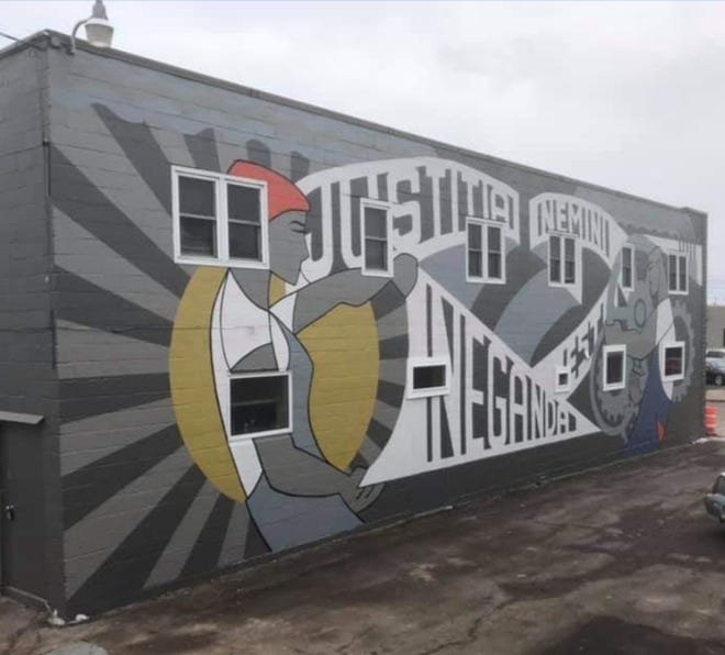 The new Fitzgerald & Bomier law office in Appleton features a mural by artist Chad Brady. Attorney Rachel Fitzgerald said the mural's saying translates to "Justice is to be denied to no one."