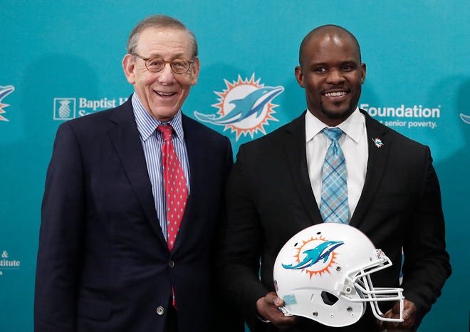 Miami Dolphins owner Stephen Ross, left, stands for a portrait with the new head coach, Brian Flores, before a news conference on Monday.