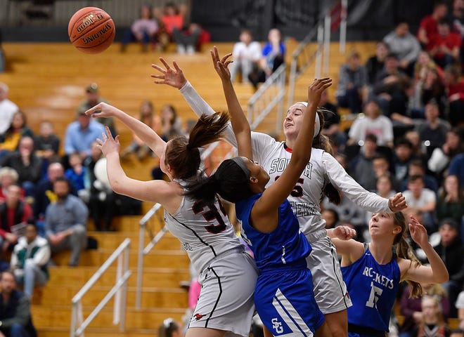 Spring Grove's Hylin Sorrell, center, battles for a rebound with Maddy McMaster (34) and Taylor Geiman (35) of South Western, Monday, Feb. 4, 2019.John A. Pavoncello photo