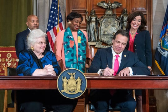 Gov. Andrew M. Cuomo, Cuomo, right, signs Reproductive Health Act Legislation during a ceremony, Tuesday, Jan. 22, 2019, in the Red Room at the State Capitol in Albany, N.Y. He is seated with Sarah Weddington, an attorney in the Roe v. Wade case.