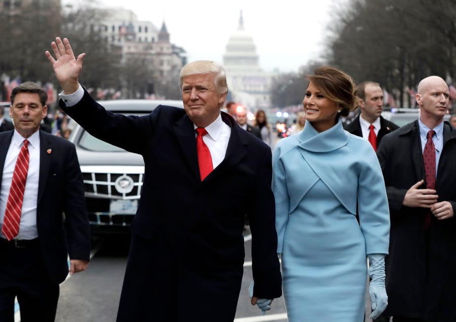 Donald Trump waves to supporters as he walks the parade route with first lady Melania Trump after being sworn in as the 45th president of the United States