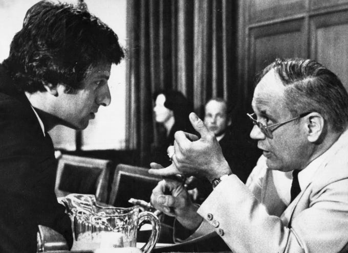 Dingell, right, chats with Rep. Toby Moffett, D-Conn., during a 1979 meeting of the House Interstate and Foreign Commerce Committee to mark up standby gasoline rationing legislation. Dingell was acting as House manager of President Carter's rationing proposal while Moffett was leading a group trying to block decontrol of oil prices.