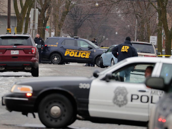 Officers block the intersection of South 12th and West Dakota streets near where a Milwaukee police officer was shot Wednesday morning on the city