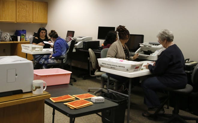 Election workers wait for ballots to come in Tuesday at San Juan County Clerk's Office in Aztec.