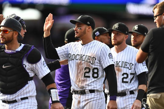 Rockies third baseman Nolan Arenado (28) celebrates after a win over the Nationals at Coors Field.