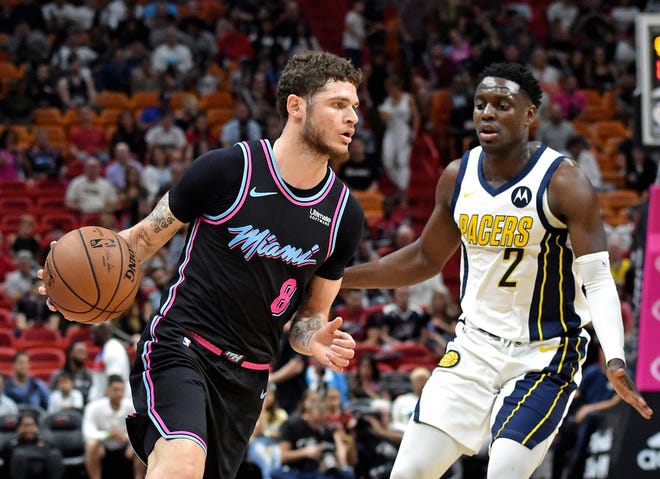 Tyler Johnson works against Pacers guard Darren Collison during the first half of a game at American Airlines Arena.