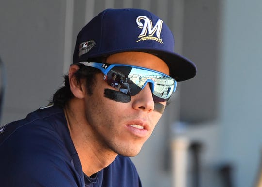 Brewers right fielder Christian Yelich  sits in the dugout before Game 5 of the 2018 NLCS.