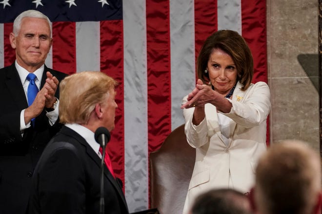 President Donald Trump turns to House Speaker Nancy Pelosi of California as he delivers his State of the Union address to a joint session of Congress on Capitol Hill in Washington, as Vice President Mike Pence watches, Feb. 5, 2019.