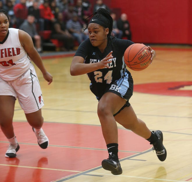 Kearney's Taylor Norris drives to the basket past Penfield's Nyara Simmons.