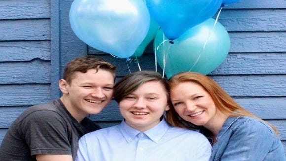 Lucas, Adrian and mom Heather Green embrace at Adrian's transgender coming out photo shoot.