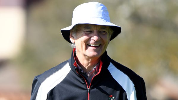 Bill Murray laughs on the second green during the...
