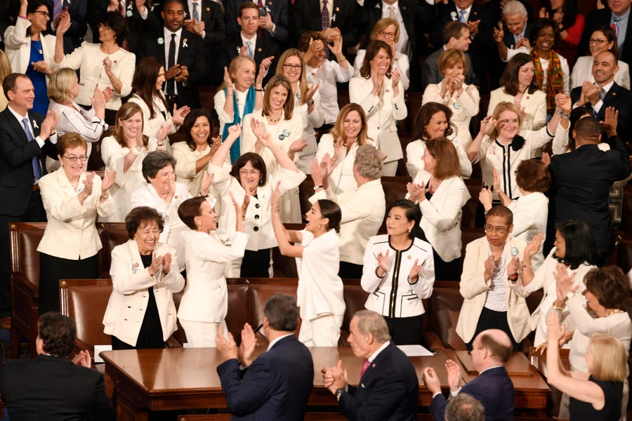 Congresswomen are recognized by President Donald Trump as he delivers the State of the Union address. The white color choice they wear is meant to honor the women's suffrage movement that led to the ratification of the 19th Amendment in 1920. 