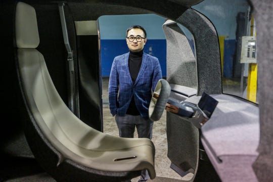 Mike Tianye Wang, CEO and Board Chairman of Quadrobot, stands in a warehouse where the "UP" package delivery truck is housed in Madison Heights, Mich. photographed on Thursday, Feb. 5, 2019.