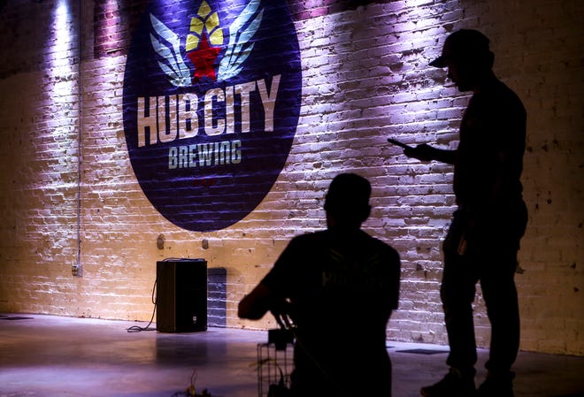 Pat Keith, a Delta Electric electrical technician, left, and Lewis Silvers with Hub City, right, test out the lights to be used on the stage at Hub City Brewing in Jackson, Tenn., on Wednesday, Feb. 6, 2019.