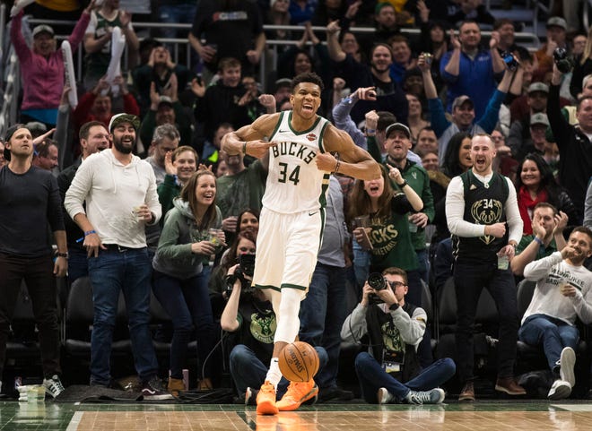 Bucks forward Giannis Antetokounmpo is pumped up, as are the fans, after he threw down a vicious dunk to cap a fast break while being fouled in the process against the Wizards on Wednesday night at Fiserv Forum.
