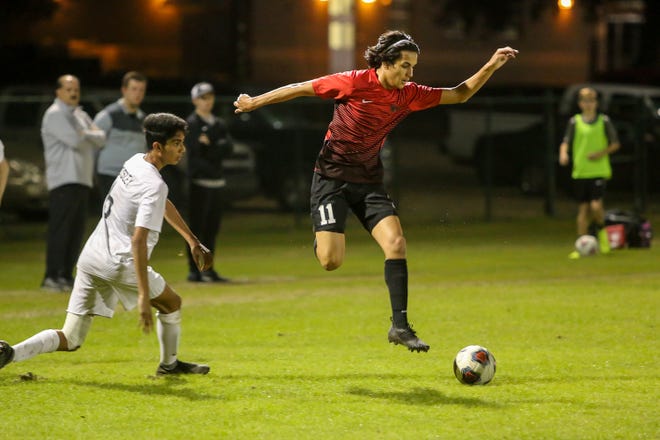 West Florida's Ron David Holland (11) jumps to avoid a tackle attempt by Mosley's Shaheer Zabih (6) in the Region 1-3A quarterfinal game at Ashton Brosnaham Park on Wednesday, February 6, 2019. Mosley beat West Florida 2-1 and advances to the next round.