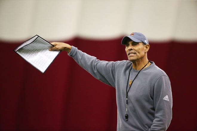 Arizona State head coach Herm Edwards leads his team during a spring football practice on Feb. 6 in Tempe.
