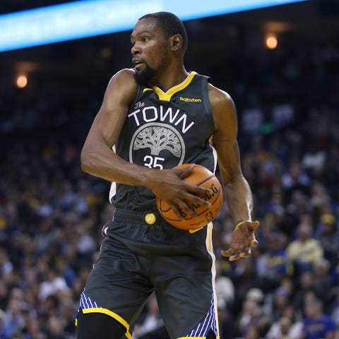 Golden State Warriors forward Kevin Durant grabs...