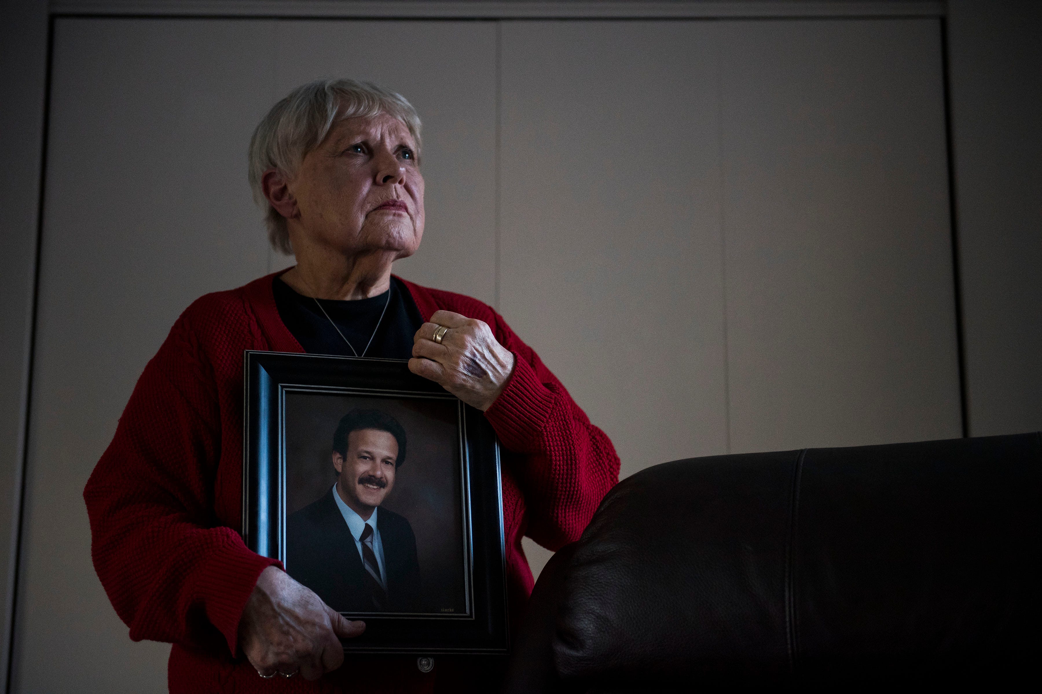 Chris Winokur with a portrait of her late husband, a former Fort Collins city councilman and mayor, in January 2019 in Estes Park, Colo. Bob Winokur was diagnosed with mesothelioma in 2015 and died nine months later