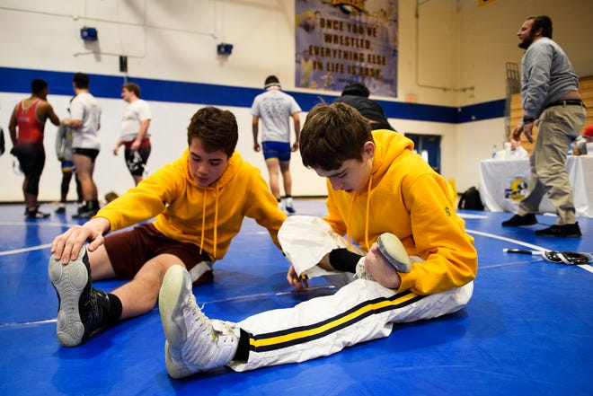 Roy Price and Taz Nelson of Eastside, stretching stretch before  the Region 2-AAAA wrestling championship, and Aden Leonard played key roles in leading the Eagles to the win in the Upper State championship on Thursday night.