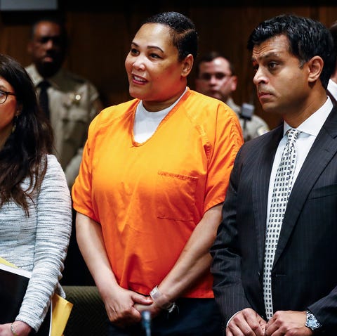 Sherra Wright, center, stands in court with her...