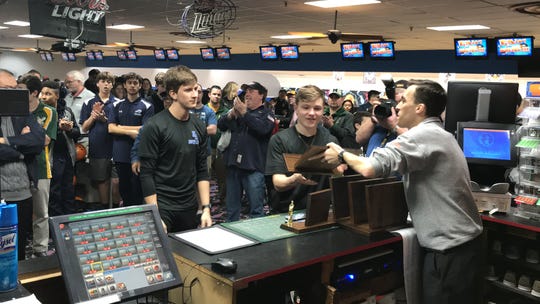 Eric McKenna (center) and members of the North Arlington boys bowling team accept the Group 1 trophy from tournament director Greg Hatzisavvas at the North 1B sectional on Thursday, Feb. 7, 2019 at Lodi Lanes.