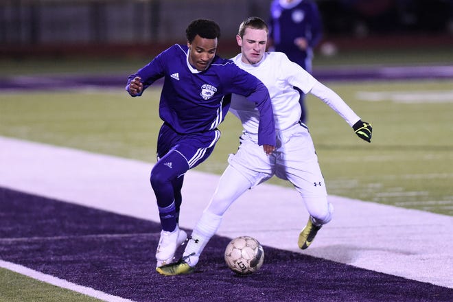 Wylie's Josiah Tuegel turns from a Stephenville defender with the ball at Bulldog Stadium on Friday, Feb. 8, 2019. The game ended in a 2-2 tie.