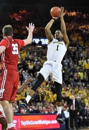 Michigan guard Charles Matthews (1) hits a shot in the last minute in the second half Saturday against Wisconsin. Matthews scored 16 of his 18 points in the second half in a 61-52 Wolverines' victory over the Badgers.