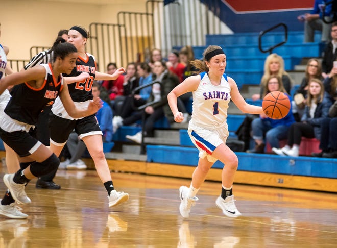 Players from Marine City High School chase St. Clair's Julianna Cataldo (1) as she runs with the basketball during their game Friday, Feb. 8, 2019 at St. Clair High School.
