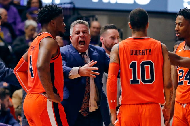 Auburn head coach Bruce Pearl talkis to players Malik Dunbar (left), Samir Doughty (center) and Anfernee McLemore (right) during a loss at LSU on Feb. 9, 2019, in Baton Rouge, La.
