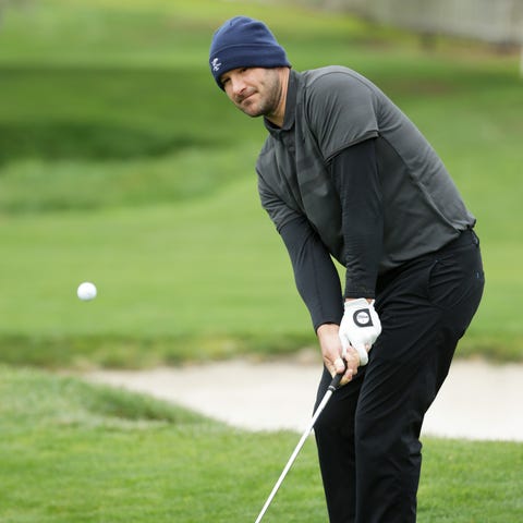 Tony Romo plays a shot on the second hole during...