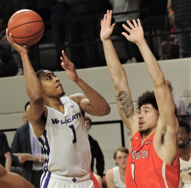 ACU's Jaren Lewis, left, shoots over a Sam Houston State's R.J. Harris. Lewis' basket tied the game at 83 with 1:25 left in the second overtime. The Bearkats beat ACU 90-85 in double overtime Saturday, Jan. 9, 2019, at Moody Coliseum.