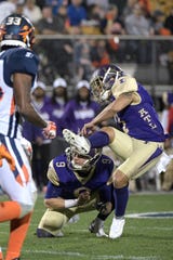Atlanta Legends kicker Younghoe Koo, right, kicks a 27-yard field goal out of the hold of Cameron Nizialek (9) during the first half of an Alliance of American Football game against the Orlando Apollos on Saturday, Feb. 9, 2019, in Orlando, Fla. (AP Photo/Phelan M. Ebenhack)