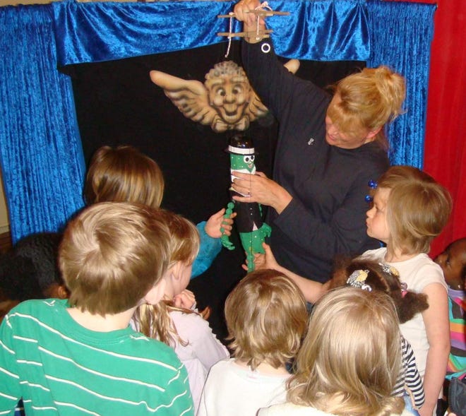 Puppeteer Linda Mason demonstrating a puppet for children.