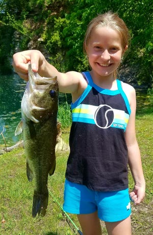 Ella Kisner of Oelwein, Iowa, with a bass caught in a rural Buchanan County pond.