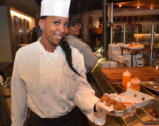 Princess Cosey displays Calderone Club meatballs at a new stand on the Fiserv Forum upper concourse.