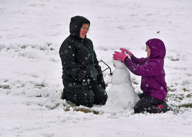 Katrina Patton, left, and daughter Jordan, 12, of Springettsbury Township, build a snowman at Springettsbury Park, Monday, Feb. 11, 2019.
John A. Pavoncello photo