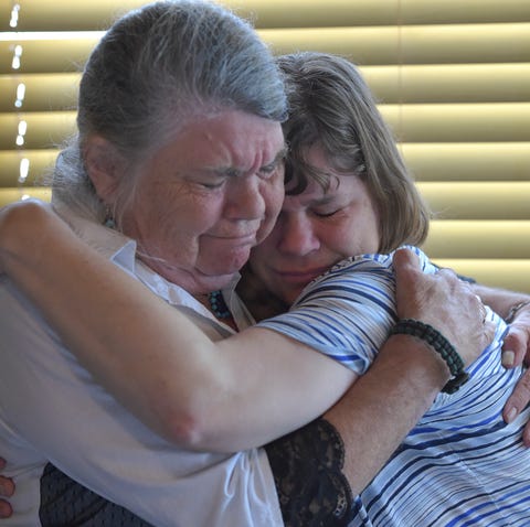 Janet Blanchard (left), of Sebastian, embraces...