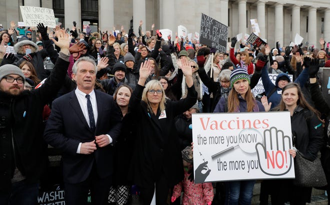 Robert Kennedy Jr., left, stands with participants at a rally held in opposition to a proposed bill that would remove parents' ability to claim a philosophical exemption to opt their school-age children out of the combined measles, mumps and rubella vaccine, on Feb. 8, at the Capitol in Olympia, Wash.