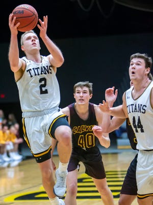 Ben Boots puts up a shot for UW-Oshkosh as Jack Flynn, right, watches during a game against Calvin College earlier this season at Kolf Sports Center.